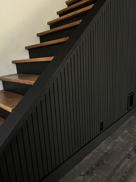 black accent wall tutorial, easy diy, diy project, slat wall, diy slat wall, pole wrap, stairway, moody decor, black wall, diy home projects, black slat wall, modern interior design, moody design, black accent wall, Wood Slat Accent Wall Stairs, Black Feature Wall Staircase, Black Wall On Staircase, Downstairs Wall Ideas, Black Walls With Accent Wall, Black Slat Wall Entryway, Black Farmhouse Accent Wall, Accent Wall Around Door, Black Basement Stairwell