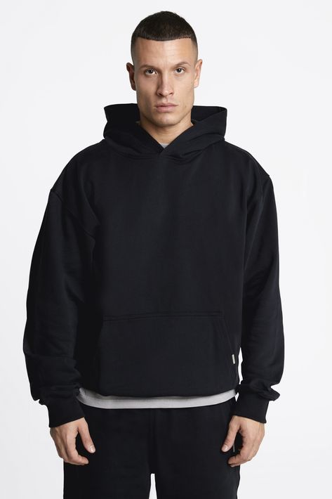 Black loopback hoodie is a heavyweight 450gsm jersey, 100% organic cotton with an oversized fit. Ribbed hem and cuffs. The black hoodie features our own metal logo attached to the pouch pocket.    Composition: 100% Organic Cotton  Oversized fit  Loopback overhead hoodie  Pre-shrunk and soft  450gsm: Made to last    Made in Portugal. Sustainably and ethically produced Black Luxury Hoodie, Black Hoodie Men, Gildan Hoodie, Black Luxury, Metal Logo, Cotton Hoodie, The Pouch, Metallic Logo, Black Design