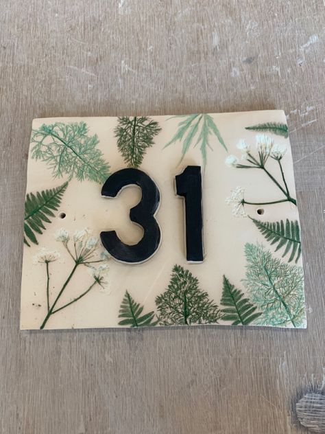 Handmade house number tile with rolled plants. Not yet had a final firing. Ceramic House Name Plaques, Ceramic Numbers House, Clay House Numbers, House Number Ceramic, Stairs And Hallway Ideas, Tile House Numbers, House Name Signs, Handmade House, Number Tiles