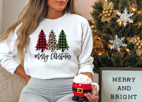 This super cute and trendy Buffalo Plaid and Animal Print Christmas Trees Sweatshirt would be perfect for Christmas or anytime this Holiday season, either way you will be amazingly comfortable and so beautiful!   Please keep in mind that if you choose an "ASH GREY" or "SAND" colored sweatshirt, your design may not "pop" as much as it would if I was to put it on a "WHITE" sweatshirt.  The design will still look great just not as much contrast with some of the design colors :) ♥ UNISEX CREWNECK SW Pj Day, Christmas Pullover, Baby Graphic Tees, Purple Tee, Christmas Crewneck, Nurse Sweatshirt, Red Tee, Holiday Sweatshirt, Holiday Shirt