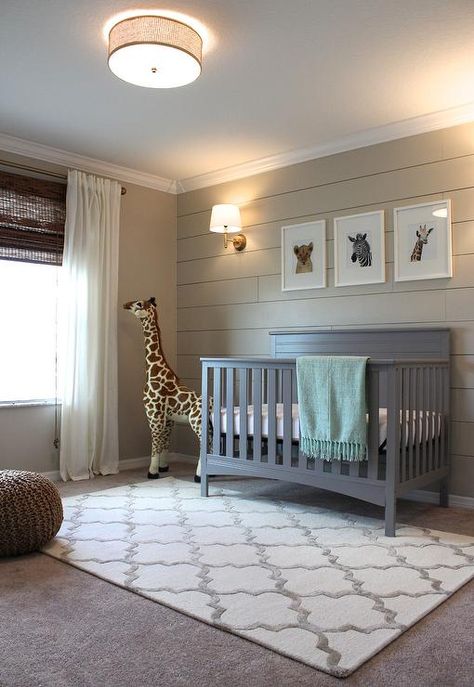 Cozy gray and beige boy's nursery is fitted with gray carpeted floors accented with a Hacienda Park Avenue Trellis Nickel Geometric Area Rug sat beneath a gray Delta Crib positioned beneath three baby animal prints from The Animal Print Shop mounted on a shiplap wall painted in Sherwin Williams Accessible Beige illuminated by a House of Troy Greensboro 13" Pin-up Wall Lamp. Transitional Nursery, Grey Nursery Boy, Shiplap Accent Wall, Baby Boy Bedroom, Baby Boy Room Nursery, Nursery Room Boy, In The Corner, Boy Bedroom, Baby Bedroom