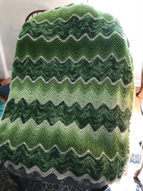 "A really special gift to celebrate Irish heritage.  A fun handmade afghan to celebrate St. Patrick's Day and beyond!  This 48\" X 38\" green ombre pattern stripe alternates with a variegated green accent.   Price:  $85.00 with free shipping.  Easily machine washable and dryable--gets softer with every wash!  Just in case some \"celebration\" gets spilled on it...    Erin go Bragh!" Crotchet Blanket Patterns, Chevron Blankets, Green Crochet Blanket, Green Afghan, Chevron Blanket, Ombre Pattern, Erin Go Bragh, Tie Blankets, Crochet Blanket Afghan