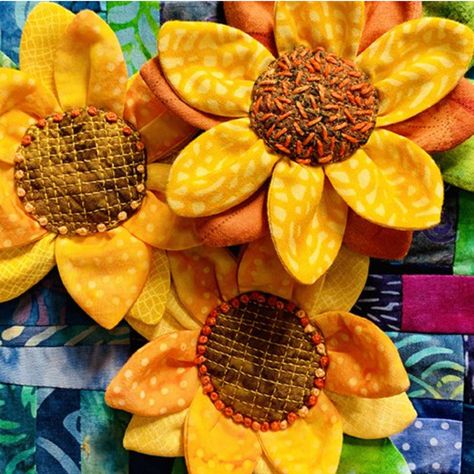 In an effort to raise money to help Ukrainians, Susan Brubaker Knapp, fiber artist created a pattern for a beautiful sunflower pin. The sunflower is the national flower of Ukraine! Susan is offering the pattern for this pin FREE at her website here: https://susanbrubakerknapp.com/tutorials. In exchange for the free pattern, we encourage you to contribute what you can to World Central Kitchen, which is feeding refugees from Ukraine and those who remain in Ukraine. How To Make Sunflower, Thread Sketching, Quilting Art, Sewing With Nancy, Fabric Flower Pins, Sunflower Quilts, Ribbon Rosettes, National Flower, The Quilt Show