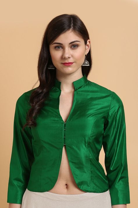 "Simple can be beautiful! In a regal shade of Green and an unconventional jacket-style pattern, this is a delightful silken blouse. An effortless style statement\n\n\n\n Color - A beautiful Green. We can also make this design in a colour of your choice.\n\n Fabric - Pure Silk\nPlease allow 10-12 business days for despatch.\n\n\n\u00a0\nContact us on  +91 73037 41333 or orders@tilfi.com for colour customisation.\n\u00a0" Banarasi Jacket, Blouse Styling, Teak Cabinet, Long Blouse Designs, Blouse Crop Top, Blouse Sewing, Sari Design, Blouse Crop, Woolen Dresses