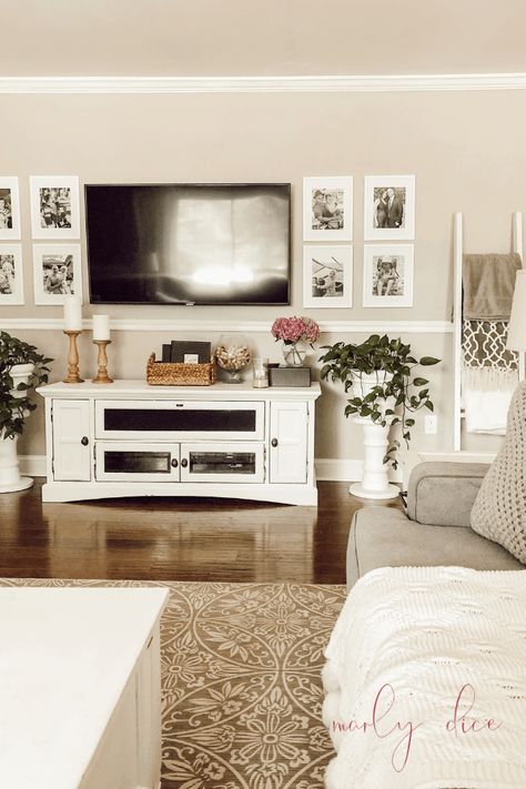 Consider creating a gallery wall to help the TV blend in a little. It will add character and color to a space that may otherwise be pretty blank. How To Decorate Around A Tv, Tv Gallery Wall, Ruang Tv, Decor Around Tv, Tv Stand Decor, Flat Screen Tv, Tv Wall Decor, Tv Wall Design, Tv Decor