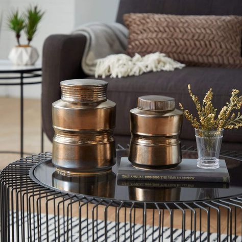 It’s easy to overlook something like a coffee table when redoing your living room. And it’s no wonder since most effort typically goes toward expensiv... | Top Your Tables with Bronze Jars Unique Jars, Rattan Coffee Table, Boho Chic Style, Boho Bedding, Ceramic Jars, Cylinder Shape, Contemporary Ceramics, Gold Wood, Ceramic Materials