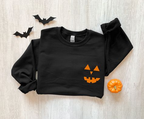 Pumpkin Sweatshirt, Halloween Sweatshirt, Jack O Lantern Sweatshirt, Fall Sweatshirt, Pumpkin Faces Shirt, Halloween Crewneck, Fall Sweater The sweatshirts are UNISEX - they are meant to have a relaxed fit, please refer to the size chart for more details. * 8.0 oz., 50/50 cotton/polyester * Pre-shrunk * Classic fit * Reduced pilling and softer air-jet spun yarn * 1x1 athletic rib knit collar, cuffs and waistband, with spandex * Double-needle stitched collar, shoulders, armholes, cuffs and waistb Minimalist Halloween, Fall Pullover, File Template, Halloween Tattoo, Pumpkin Sweatshirts, Water Mark, Skeleton Shirt, Fall Hoodies, Sweatshirt Halloween