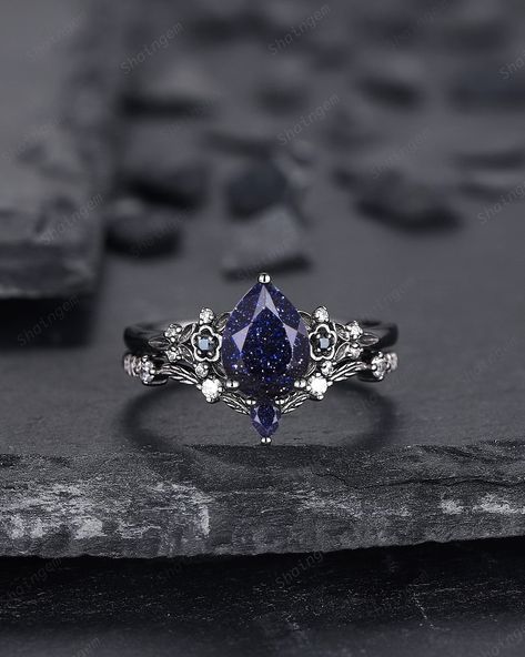 Features: Shining starry blue sandstone bridal set with solid black gold setting, star galaxy stone  is very rare to find from nature, to meet fans that're in love with such special starry fire stone, we sourced this special lab created blue sandstone, hope you could enjoy it and love it. Rhodium black engagement ring like no other. This AMAZING piece of fine jewelry is the perfect expression of your eternal love. Its BLACK colors bring out the beauty of this ring. ★Description Main ring: *Cente Engagement Rings Space, Blue Black Clothes, Dark Fairy Engagement Ring, Feyre Engagement Ring Acotar, Dark Blue Wedding Ring, Starry Engagement Ring, Blue Sandstone Engagement Ring Silver, Galaxy Ring Engagement, Night Court Jewelry