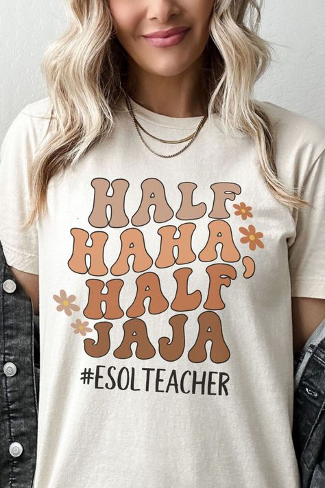 A fun and lively t-shirt with the text "Half Haha Half Jaja" displayed in a wavy retro font. This shirt is a humorous and appreciative gift for bilingual individuals, especially ESOL teachers, English teacher assistants, and first-grade teacher teams. Perfect for elementary school teachers, it's a great way to showcase bilingual pride and spread joy with this stylish and playful t-shirt. Esol Teacher Shirt, Bilingual Shirts, Esol Teacher, Teacher Team, Teacher Assistant, Ootd Inspo, First Grade Teachers, Spanish Teacher, Beginning Of School