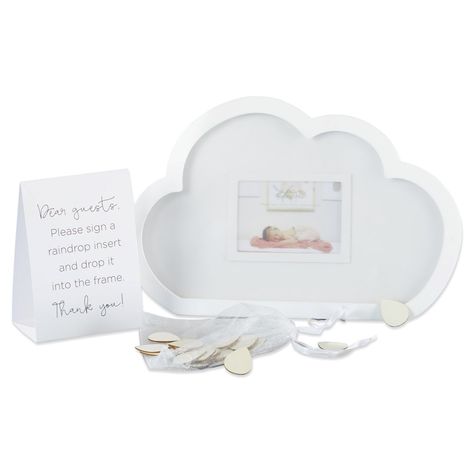 Looking for a guest book alternative? This special Cloud Frame Baby Shower Guest Book Alternative from Kate Aspen will impress your guests and leave you with the memories of a lifetime. A shadowbox frame is in the shape of a white cloud with a charming picture of your choice inside that you and your guests will enjoy viewing. The tent card has instructions for your friends and family to leave their mark. Your friends and family members can decorate a wooden raindrop with their initials or a shor Cloud Nine Baby Shower Cake, Cloud 9 Baby Shower Theme Centerpieces, Pink Cloud Baby Shower Theme, A Piece Of Heaven Baby Shower Theme, Cloud 9 Baby Shower Theme Boy, Up In The Clouds Baby Shower Theme, In The Clouds Baby Shower Theme, Cloud Centerpiece Baby Shower Ideas, Cloud Themed Baby Shower Ideas