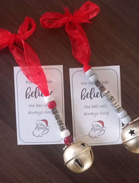 "Personalised Believe 2023 jingle bells.A large bell with star detail.Personalised with name in silver letter beads and coloured beads of your choice,with a 2023 and Believe charm.Comes on red ribbon,attached to card with quote \"for those that Believe the bell will always ring\"Perfect for Christmas eve boxes or as a stocking filler.Choose name and bead colour of your choice.Handmade. If there is a particular colour ribbon 🎀 or bead choice you require,please pop me a message ." Crafts With Bells Christmas, Letter Beads Ideas, Diy Jingle Bells, Christmas Bells Craft, Christmas Bells Decorations, Salt Ornaments, Preschool Christmas Ornaments, Bell Crafts, Homemade Christmas Gift Tags