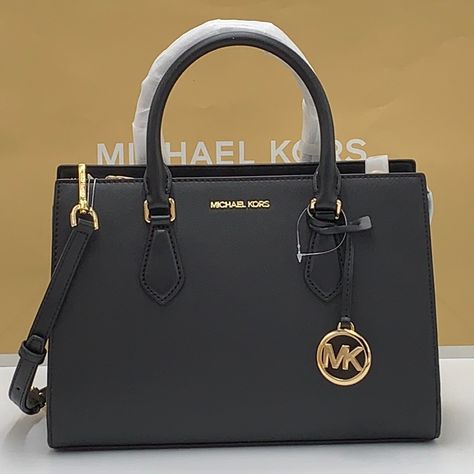 Brand New With Tag Michael Kors Sheila Medium Center Zip Satchel Bag Details Color: Black Satchel Faux Leather 88.92% Coated Canvas/11.08% Polyester Silver-Tone Hardware 11"W X 8"H 3.25"D Handle Drop: 4" Interior Details: Back Zip Pocket, 2 Front Slip Pockets Lining: 100% Polyester Zip Fastening Imported Michael Kors Bag Outfit, Michael Kors Bag Black, Work Tote Bag, Michael Kors Satchel, Black Satchel, Bag Details, Bags Michael Kors, Handbags Crossbody, Mk Bags