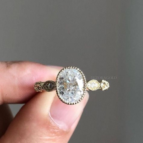 Antique Edwardian Style Oval Moissanite Engagement Ring, Milgrain Wedding Ring, Vintage Anniversary Ring, Art Deco Handmade Ring Estate Ring ✥ 𝗗𝗲𝘀𝗰𝗿𝗶𝗽𝘁𝗶𝗼𝗻 𝗢𝗳 𝗥𝗶𝗻𝗴 :- ✥ Moissanite Diamond Details :- * Center Stone Shape : 𝐎𝐯𝐚𝐥 𝐂𝐮𝐭 * Center Stone Weight : 𝟏.𝟓𝟎 𝐂𝐓 * Center Stone Measurement : 𝟖.𝟓𝟎*𝟔.𝟓𝟎 𝐌𝐌 * Side Stone Shape : 𝐑𝐨𝐮𝐧𝐝 𝐂𝐮𝐭 * Side Stone Weight : 𝟎.𝟏𝟎 𝐂𝐓𝐖 * Stone Color : Colorless * Stone Clarity: VVS * Mohs Scale : Moissanite 9.25 * Ref Oval Ring Vintage, Bezel Set Engagement Ring Silver, Vintage Gold Engagement Rings Antiques, Vintage Rings Antiques, Thick Engagement Ring, Oval Bezel Engagement Ring, Thick Engagement Rings, Edwardian Engagement Rings, Milgrain Wedding Ring