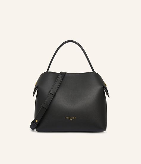 The Medium Swan bag in Black, crafted from smooth calf leather, embodies a timeless elegance that perfectly adapts to all your outfits, whether they are understated or boldly colored. Its optimal size offers sufficient space for all your daily essentials, while maintaining an elegant and streamlined silhouette. Black, as a universal and timeless color, elegantly pairs with a wide palette of colors. It harmoniously combines with neutral tones such as beige, sand, or grey, creating a classic and refined look. For a touch of boldness, pair it with vibrant colors like brick red, mustard yellow, or electric blue. Carefully made in Italy, the Medium Swan bag in black is distinguished by its discreet metallic finishes and sophisticated allure. Versatile, it can be worn in various ways: by hand, Luxury Wardrobe, Beige Interior, Bag Display, Gold Models, Metal Accessories, Leather Texture, Black Bag, Leather Care, Classic Elegance