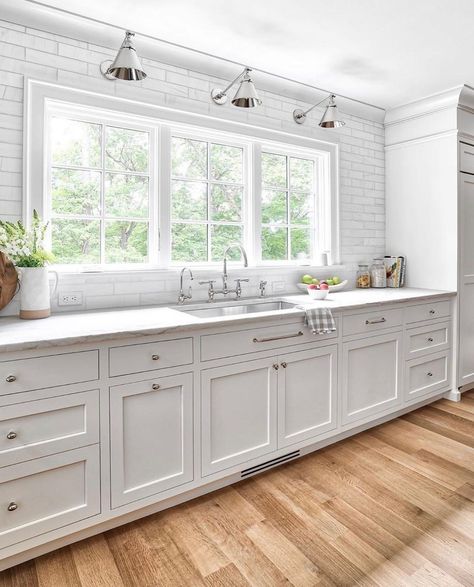 30 Gorgeous White Kitchen Cabinet Hardware Ideas Kitchen With Big Window Over Sink, Kitchen Windows Above Sink Ideas, Kitchen With Large Windows, White Kitchen Cabinet Hardware, Kitchen Window Design, Kitchen Cabinet Door Styles, Kitchen Windows, Kitchen Cabinet Styles, Cabinetry Design