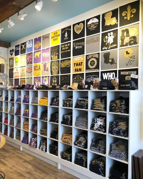 Tshirt Display Ideas Retail Store Design, T Shirt Displays Retail, T Shirt Merchandising Display, Tee Shirt Display Ideas Retail, Tshirt Wall Display Ideas, T Shirt Wall Display Ideas, Retail Merchandising Displays Clothing, Tshirt Retail Display, Screen Print Storage Ideas