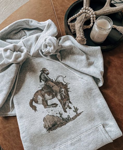 Western graphic hoodie. Bucking bronc. Paint horse. Western style. Click the link to order yours. Western Hoodies, Hoodie Design Ideas, Western Fits, Western Sweatshirts, Horse Western, Paint Horse, Western Clothing, Horse Painting, Christmas 2024