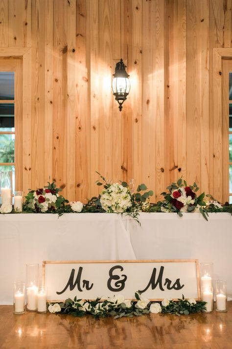 | maroon + white wedding flowers | head table wedding decorations | modern rustic wedding decorations | farmhouse wedding reception decorations | farmhouse wedding head table decor | farmhouse wedding sweetheart table | photo taken at THE SPRINGS Event Venue. follow this pin to our website for more information, or to book your free tour! SPRINGS location: The Ranch in Denton, TX photographer:  Kylie Crump Photography #weddingflowers #weddingreception #farmhousewedding #headtable #sweethearttable Wedding Head Table Decor, Wedding Reception Head Table, Ranch Style Weddings, Head Table Wedding Decorations, Wedding Head Table, Head Table Decor, Farmhouse Table Decor, Head Table Wedding, Sweetheart Table Wedding