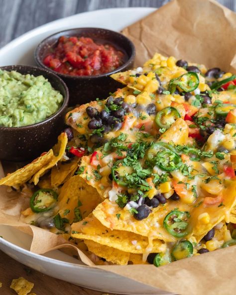 When it comes to game day party grub, these Loaded Vegetarian Nachos are a surefire winner! 🏈 🎉 Layers of crunchy tortilla chips, black beans, corn, bell pepper, red onion, jalapenos, and ooey gooey melty cheese 🧀 come together to create the perfect touchdown-worthy snack! 🙌 Serve these mouthwatering veggie nachos with an array of your favorite dips like sour cream, salsa, and guacamole. 🍅🥑 Comment "nachos" below for the recipe! #SuperBowlFeast #GameDayEats #NachosForTheWin #vegetariannac... Nachos With Jalapenos, Nachos Vegetarian, Mediterranean Nachos, Veggie Nachos, Salsa Nachos, Salsa And Guacamole, Vegetarian Nachos, Black Beans Corn, Vegan Nachos