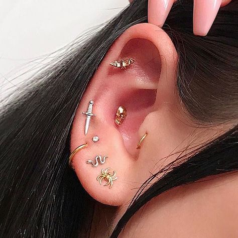 Archives: just in time for Halloween, Savannah’s spooky ear from a couple years ago. I stacked her 3rd hole with a diamond, pierced her 4th with this white gold dagger and conch with this giant gold skull. All of these pieces are available for custom ordering (email only please)! #newyorkadorned #piercer #piercing #allgoldeverything #safepiercing #piercingsofinstagram #piercinginspiration Goth Ear Piercings, Different Ear Piercings, Horn Pendant Necklace, Cute Ear Piercings, Cute Piercings, Types Of Piercings, Swarovski Necklace, Rhinestone Designs, Piercing Tattoo