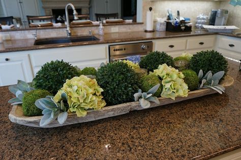 A good start, but needs artichokes and less ball-shaped boxwoods. Kitchen Island Centerpiece Ideas, Table Centerpiece Tray, Kitchen Island Decor Centerpieces, Island Centerpiece Ideas, Kitchen Island Centerpiece, Kitchen Island Decor Ideas, Dough Bowl Centerpiece, Centerpiece Tray, Dough Ideas