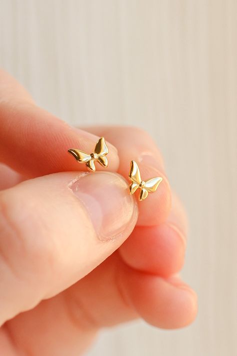 Yes, yes, yes!!! This tiny butterfly stud is made with 18k gold plated 925 sterling silver and is the HIGHEST quality, so it is completely safe for even the most sensitive ears. This stud is great for all ages, has stunning details, and is such a staple piece! This stud is also extremely tarnish resistant and so feminine and dainty! This stud is .25 inch in length. Floral Stud Earrings, Tiny Gold Jewelry, Small Gold Tops Designs, Gold Earrings For Gift, Small Gold Earrings Designs, Earring Designs Gold, Gold Studs Earrings Indian, Ear Rings Gold, Gold Earrings Studs Simple