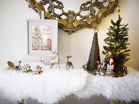 Full view of our #entryway #foyer #tablescape. #IKEA faux #sheepskin #rug. Round #mirrortray from #jossandmain. #royaldoulton #santa #figurine. #vintagebrass #reindeer #santasleigh #indigofaves #myhomesense #homesense #xmasdecor #entrydecor #foyerdecor #interiorstyling #homedecor #CGLxmas #CGLdecor #waterlogue #minixmastree #LEDstringlights #tablerunner #tablescape #BHGCelebrate #CGLentryway Mantle Scarf, Faux Fur Area Rug, Fur Decor, Christmas Mantle Decor, Faux Snow, Beautiful Christmas Decorations, Christmas Mantle, Window Bed, Window Styles