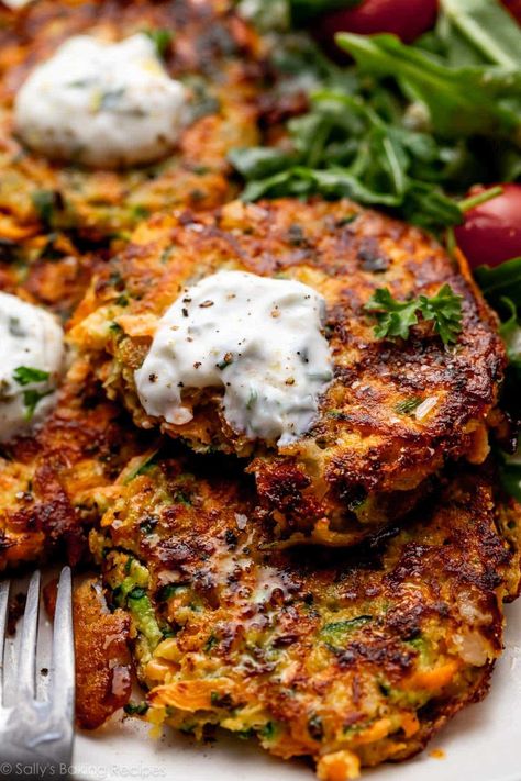 Golden brown and crisp, these delicious zucchini sweet potato fritters are naturally gluten free and taste incredible with cool and creamy yogurt sauce. Flavored with onion, garlic, and fresh herbs, these savory little cakes cook quickly on the stove and are welcome at breakfast, lunch, and dinner. Recipe on sallysbakingaddiction.com Recipes With Zucchini, Roasted Vegetable Lasagna, Sweet Potato Fritters, Potato Fritters, Vegetable Lasagna, Sally's Baking, Zucchini Fritters, Roasted Vegetable, Fritter Recipes