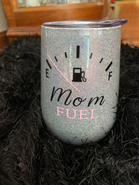 Mom Fuel wine tumbler is a stainless steel, epoxy coated, 12 oz wine tumbler. It is covered with holographic silver glitter and available in multiple other holographic glitter colors. This makes for a cute mother's day gift or birthday present that a tired mom would love! The multiple layers of epoxy seal the glitter and vinyl to give a smooth, glossy, and protective finish. This tumbler is safe to use with hot and cold drinks and the epoxy adds to the insulation, keeping drinks hot and cold for Wine Tumbler Gift Set, Glitter Wine Tumbler Ideas, Grandma Tumbler Ideas, Wine Cups Vinyl Ideas, Tumbler Ideas For Moms, Mom Tumbler Ideas, Mothers Day Tumblers, Wine Tumbler Ideas, Glitter Tumbler Ideas