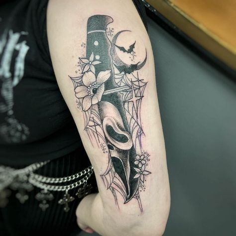 Wonderful Ghostface Tattoos With Floral Motif Womens Horror Tattoos, Scream Tattoo With Flowers, Horror Leg Sleeve Tattoo Women, What's Your Favorite Scary Movie Tattoo, Subtle Horror Tattoo, Halloween Themed Tattoos Sleeve, Small Horror Movie Tattoo Ideas, Spooky Thigh Tattoos Women, Horror Sleeve Tattoos For Women