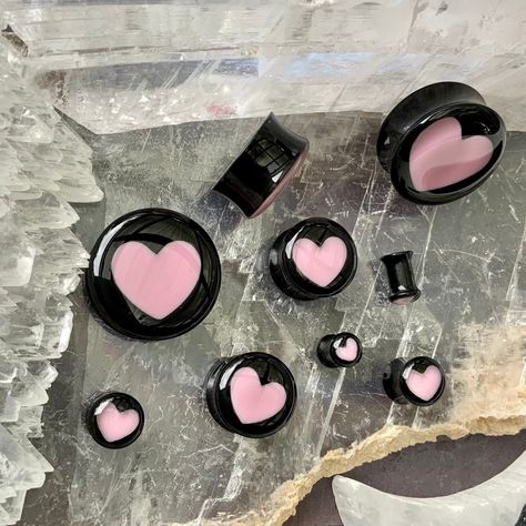 "WELCOME TO PINK ALIEN BABE  YOUR ONE STOP SHOP FOR ALL THE CUTEST PLUGS AND ACCESSORIES IN THE GALAXY 🪐⭐️ 🎀This is a listing for A PAIR (two pieces) of Aphrodite Inner Love ear plugs, black acrylic double flared gauges with baby pink hearts inside of them in your choice of size.  👽💕 Sizes available: 2g 6mm, 0g 8mm, 00g 10mm, 1/2\" 12mm, 9/16\" 14mm, 5/8\" 16mm, 11/16\" 18mm, 3/4\" 20mm, 7/8\" 22mm, 1\" 25mm, 28mm, 30mm, 32mm, 34mm, 36mm, 38mm, 40mm, 42mm, 44mm, 46mm, 48mm, 2\" 50mm 👽💕 Loo 8 Gauge Ears, 12 Mm Gauges, Cute Gauges Plugs, Cute Ear Gauges, Heart Gauges Plugs, Eat Gauges, Double Gauged Ears, 00 Gauges In Ear, 0g Stretched Ears