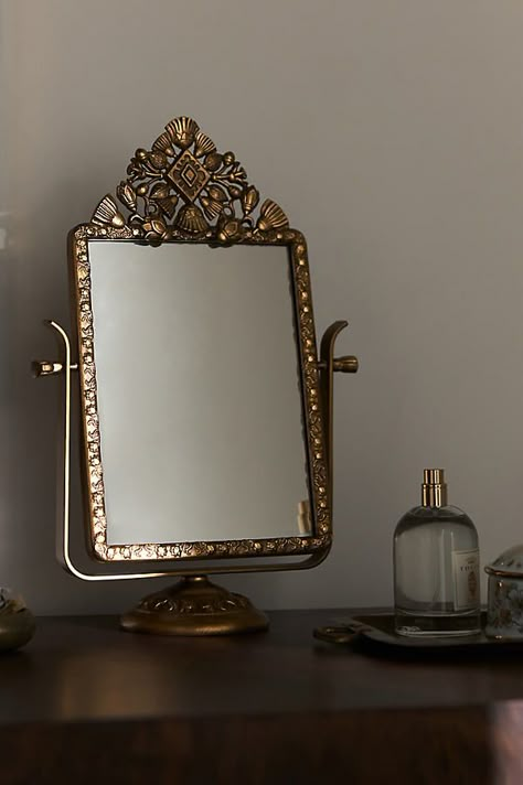 An embellished gold frame makes this mirror a timeless staple. | Coralie Petite Vanity Mirror by Anthropologie in Brown Anthropologie Kitchen, Hummingbird Wall Art, Curated Decor, Anthropologie Home, Marble Jewelry, Glass Vanity, Outdoor Holiday Decor, Metal Candle Holders, Small Mirrors