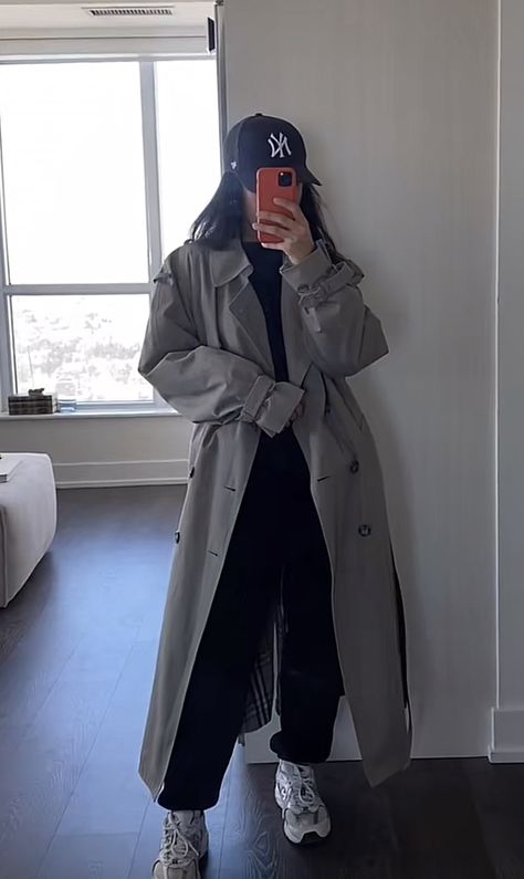 Trench Coat Tracksuit Outfit, Light Grey Trench Coat, Airport Trench Coat Outfit, Long Black Raincoat Outfit, Sweatpants Trench Coat, Trench Coat With Sweatpants, Styling A Trench Coat Outfit, Grey Raincoat Outfit, Charcoal Trench Coat Outfit