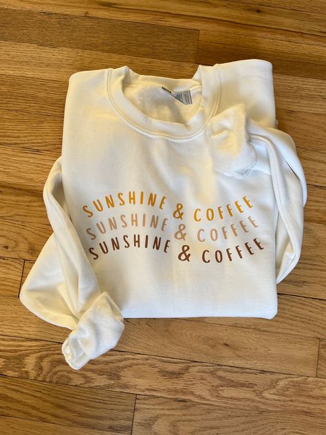 "This \"Sunshine & Coffee\" sweatshirt will be one of your favorites. Wear it on a cold winter day while you dream of summer or a cool summer evening by the fire.  It is a white Gildan 18000 sweatshirt with a custom heat transfer vinyl transferred on. This item is handmade therefore it is delicate. Treat this item with love so you can love it longer. Please wash on delicate inside-out and air dry or dry on low inside-out." Coffee Sweatshirt Design, Sweatshirt Designs Ideas, Cute Tshirts Women, Cricut Crew Neck Sweatshirt, Sweatshirt Designs Vinyl, Cricut Sweatshirt Ideas, Sweatshirt And Shirt Outfit, Sweaters Aesthetic, Sunshine And Coffee