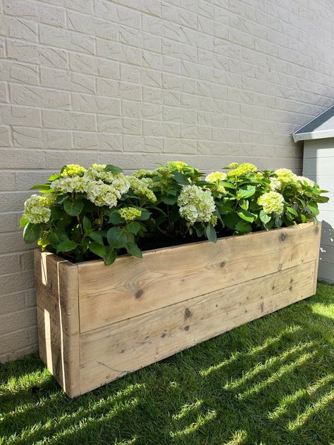 Modern rustic reclaimed wooden garden planter. Made from reclaimed scaffold boards.  Ideal for outdoor plants, flowers, herbs and vegetables. Features holes for drainage and is positioned on top of small wooden feet.  Pictures of the example pieces may slightly vary, as each piece of reclaimed wood is different and reacts differently to stains/oils. The time of the year also has an effect on the woods natural colour too. Our pieces are coated in Osmo Poly oil then second coated in clear boiled l Wooden Raised Beds, Garden Troughs, Herb Boxes, Rustic Planters, Wood Planter Box, Wooden Planters, Garden Planter, Wood Planters, Garden In The Woods