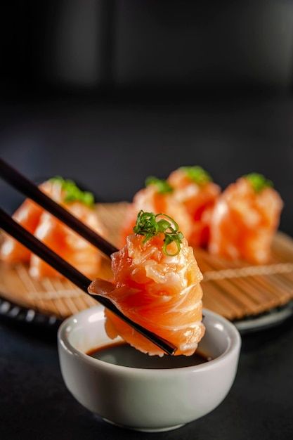 Photo salmon jhow sushi on chopsticks on... | Premium Photo #Freepik #photo #sashimi #salmon-sashimi #sushi-restaurant #sushi Foto Sushi, Japanese Food Photography, Sushi Rice Recipes, Salmon Sashimi, Salmon Sushi, Restaurant Photography, Best Sushi, Food Content, Japanese Sushi