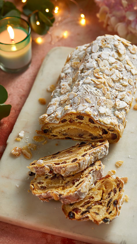 Christmas stollen with slices cut out on a marble board Christmas Stollen Bread, Stollen Bites Recipe, Baking Website, Christmas Stollen Recipe, Stollen Cake, Stollen Bread, Christmas Pastry, Christmas Stollen, Stollen Recipe