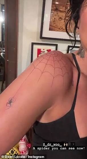 It shows Demi Lovato's shoulder tattoo, which is a spiderweb. Spider Web Shoulder Tattoo, Shoulder Cap Tattoo, Spider Web Tattoo, Web Tattoo, Flame Tattoos, Spider Tattoo, Forearm Tattoo Women, Dope Tattoos For Women, Shoulder Tattoos For Women