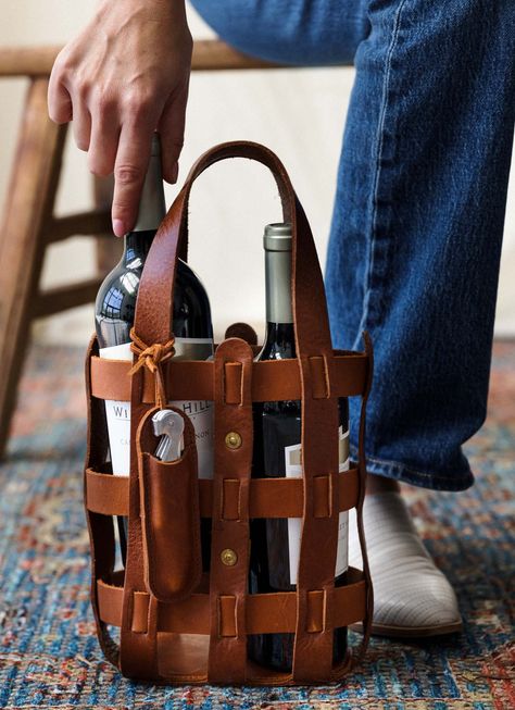 One is the loneliest number. Our leather wine tote carries two bottles of your wine with ease and style. Made with full-grain strap leather and woven together to create the perfect pairing to your grapes. A corkscrew pouch is included (which can also be monogrammed to make a great gift for the wine lovers in your life). Materials Dimensions 100% Full-Grain Leather Carries 2 bottles of wine Pouch for corkscrew Width: 9" Height: 13.5" Depth: 3.5" Leather Wine Tote, Leather Wine Carrier, Wine Key, Everyday Carry Bag, Diy Leather Projects, Leather Dopp Kit, Wine Carrier, Wine Bottle Bag, Leather Apron