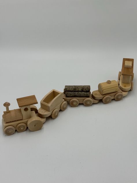 All aboard! This beautifully handcrafted wooden train set is the perfect toy to spark your child's imagination and creativity. Designed with care and attention to detail, this charming train set is made from high-quality, natural wood, ensuring it's as durable as it is delightful. The set includes a locomotive engine and four distinct train cars, each crafted with smooth, rounded edges to ensure safe play for little hands. The natural wood finish highlights the unique grain and texture of the wood, making each piece truly one-of-a-kind. This timeless toy is perfect for kids who love to build, push, and create their own adventures. Ideal for toddlers and young children, this wooden train set is not only a fun plaything but also a beautiful piece of craftsmanship that can be passed down thro