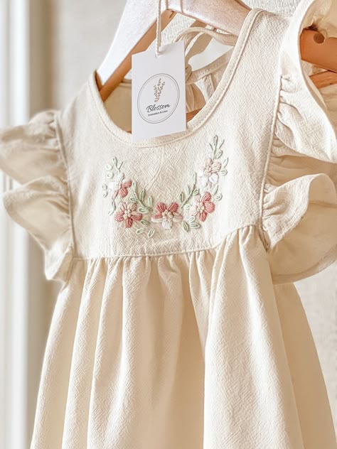 Delicate spring linen dress for girl, hand embroidered dress with floral design. Ideal for a special occasion or to enjoy it at any time of the day. Baby dress and children's dress made of soft and fresh fabric for Spring Summer, cream-colored linen with embroidery in pure cotton thread in neutral tones. Emma dress, represents our Blossom collection of hand-embroidered linen dresses in different colors. Flower designs with simple lines represent nature thus creating unique and very special garments. The dresses are made of linen and cotton fabric. Dresses with ruffles on the sleeves and a wide skirt. On its front it has a floral design embroidered by hand with pure cotton threads. For this collection we select pastel colors, soft tones combined to perfection. We design garments for babies Embroidered Toddler Dress, Dresses With Embroidery, Fall Linen, Baby Dress Embroidery, Hand Embroidered Dress, Girls Spring Dresses, Hand Embroidery Dress, Toddler Summer, Girl Hand