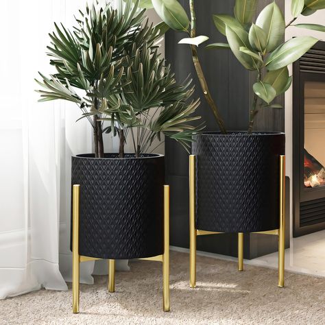 PRICES MAY VARY. A geometric diamond-shaped pattern offers a stylish look to the planter pots, while the gold stands give it a luxury contemporary vibe. Each gold stand is sturdy and will securely hold metal cachepots while the stand foot pad designs protect floor to prevent any scratches or scuffs. Crafted from durable iron, all metal cachepot planter set includes 1 large cachepot, 1 small cachepot, and 2 gold stands. Decorative planter set: these metal planter pots have no drainage holes; leav Gold Planter, Black Planters, Metal Plant Stand, Floor Plants, Luxury Contemporary, Metal Planters, Decorative Planters, Indoor Plant Pots, Metal Stand