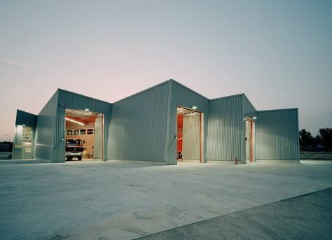 pivoting around a central hall, the fire station features four garage doors that fan out towards the road for easy and efficient access. Fire Station Architecture, Fire Hall, Central Hall, Town Building, Cool Fire, Hall Design, Building Structure, House Fire, Fire Rescue