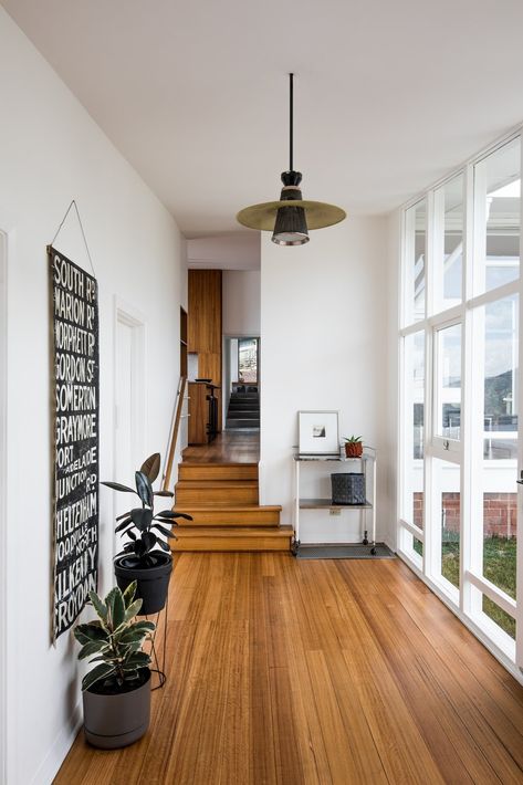 An Architect's 1958 Midcentury in Tasmania Gets a Graceful Renovation - Photo 4 of 15 - Inside the entry, which affords a view through the house towards the extension, Emery's original palette combines white walls with wood floors. Mid Century Modern Flooring, Modern Wood Floors, Modern Flooring, Mid Century Modern Bedroom, Midcentury Home, Mid Century Living Room, Mid Century Modern Living Room, Wooden Floors, Mid Century Modern Decor