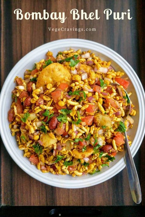 Bhel Puri is a popular Indian snack made with puffed rice, vegetables like boiled potatoes, tomatoes & onions, flavored with tangy chutneys. Bhel Puri Recipe, Bhel Recipe, Chats Recipe, Bhel Puri, Potatoes Tomatoes, Puri Recipe, Indian Veg Recipes, Veg Snacks, Puri Recipes