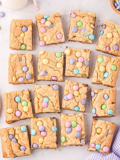 Overhead shot of squares of cookie bars with m&m on top and some around it, a cloth, and a cup of milk. Easter Cookie Bars, Easy Easter Cookies, Crispy Honey Chicken, Snickerdoodle Cookies Easy, Refrigerated Cookie Dough, Chocolate Chip Cookie Mix, Cookie Toppings, Sugar Cookie Mix, Coconut Cheesecake