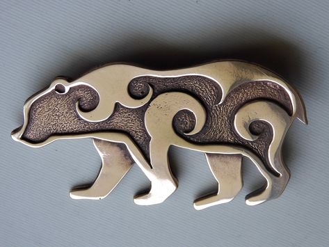 I make this bronze bear comes as either a brooch or a pendant.   The design was inspired by Pictish animals found carved on stones in Scotland.  The last picture shows an example of a bear. This is a large piece which measures 7 cm from nose to tail and is 4 cm at the shoulder. The pendant has two loops on the back for a cord or chain. It also looks great sewn on the flap of a pouch! GST is already included in the price on all Canadian sales. Copper Uses, The Last Picture Show, Hood Ornaments, Bear Pendant, Metal Work, Silver Pieces, Metal Jewelry, Metal Working, Brooch Pin