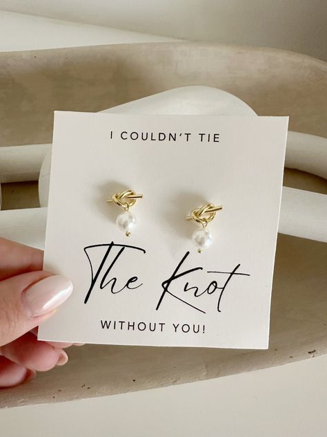 -----DETAILS---- This listing is for a pair of I couldn't tie the knot without you gold pearl earrings These are made with 18k gold plated over 952 sterling silver ---HOW TO ORDER--- 1- Please select quantity and color option  2- Add to your cart  3- Please leave me any personalization in notes to seller box  4- Checkout --CURRENT PROCESSING TIME--- My current processing time is 1-2 weeks on all products! If you need your item sooner, please send me a message and I will do my best to accommodate Bride Maid Boxes, Ask Bridesmaid Ideas, Dior Bridesmaid Proposal, Bridesmaid Must Haves, Unique Bridesmaids Proposals, Ask To Be A Bridesmaid Ideas, Sentimental Bridesmaid Gifts, Minimal Bridesmaid Proposal, Bridesmaid Proposal Classy