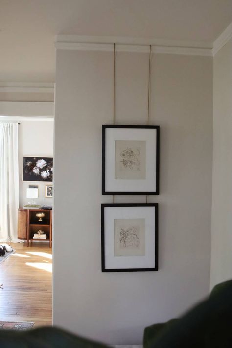 If you're looking to hang wall art without using nail holes, look no further than a picture rail hanging system! Find details about one of the best ways to add character to a modern home!