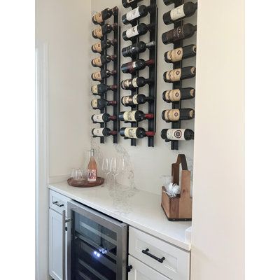 Scale a column of Bronc Vino Pins straight up the wall to maximize space or tilt them up to 45 degrees for a designer’s edge-to-wine storage with the Bronc Vino Pins Flex system. Flex offers a dynamic mounting option to Latitude Run®’s patented wine peg system with the addition of a simple vertical mounting system that mixes up the aesthetic and simplifies installation. This complete system includes everything you need to install one column of label-forward Vino Pins and a choice of bottle depth Modern Wall Wine Rack, Built In Wine Bar, Wine Wall Display, Wall Hanging Wine Rack, Small Wine Racks, Wine Room Design, Home Wine Bar, Black And White Dining Room, Wine Bottle Wall